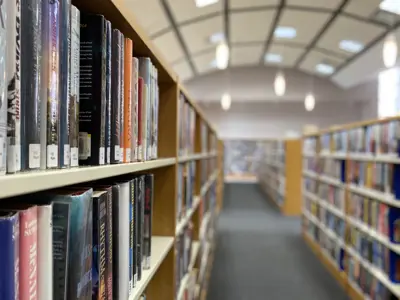 aisle shot in between rows of shelves of books